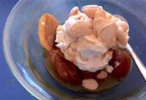 Simmered apricots and lemons with whipped cream and almonds