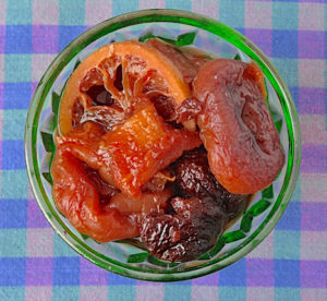 Simmered apricots, cherries, pineapple and lemons Depression glass compote