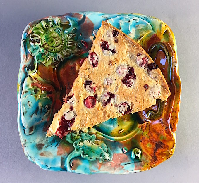 Slice of warm cranberry torte Earthenware plate by Lisa Orr