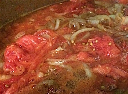 Onions, garlic and peeled roasted tomatoes simmering into sauce photo by Iris Kimberg 