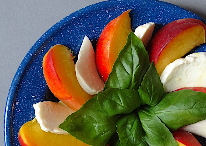 Peaches, mozzarella and fresh basil leaves