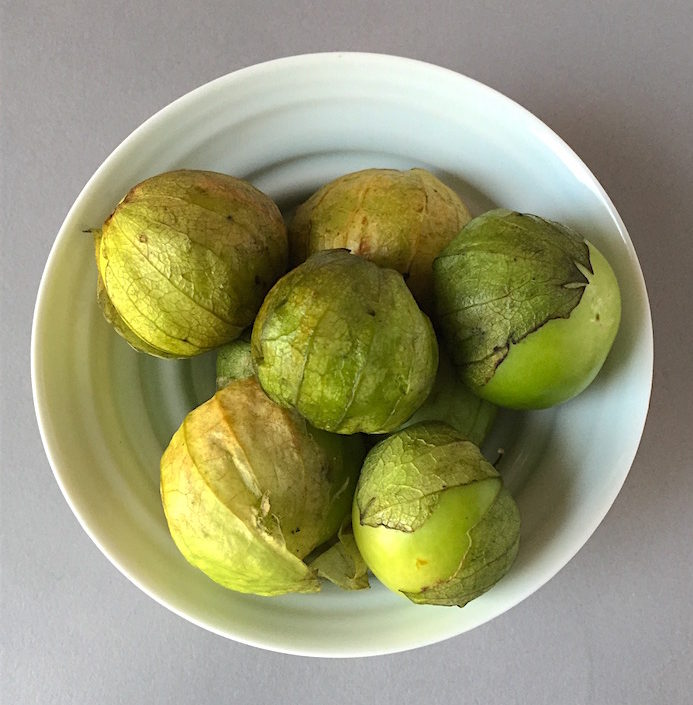 Fresh tomatillos in a porcelain bowl by James Makins 